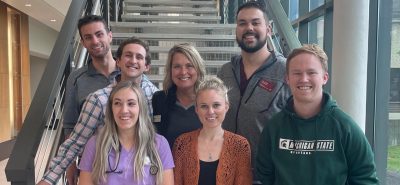 Group of people smiling for a photo.