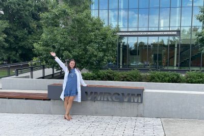 Veterinary student standing outside in from on the Virginia-Maryland College of Veterinary Medicine building.