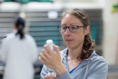 Robyn Fox holding a syringe and medicine bottle in the Veterinary Teaching Hospital.