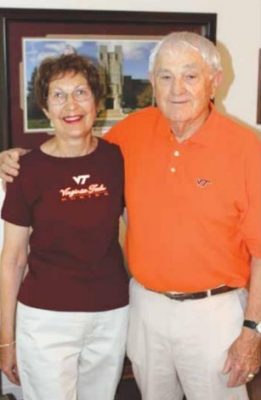 Two people wearing Virginia Tech gear.